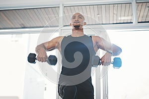 Fitness, dumbbell and black man in gym for training, workout and wellness for healthy routine. Sports, male person and