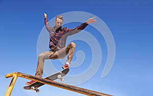 Fitness, energy and man with skateboard, jump or rail balance at a skate park for stunt training. Freedom, adrenaline