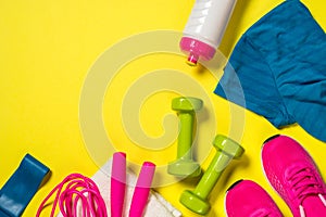 Fitness equipment flat lay image on color background.