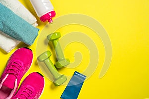 Fitness equipment flat lay image on color background.