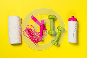 Fitness equipment flat lay image on color background.