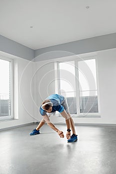 Fitness Exercise. Man Stretching Warming Up Body Before Training