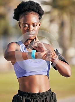 Fitness, exercise and woman checking her pulse with smartwatch for running outdoor in nature. Sports, workout and