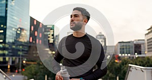 Fitness, face and thinking, man in city on rest from morning workout with water bottle. Relax, breathing and tired