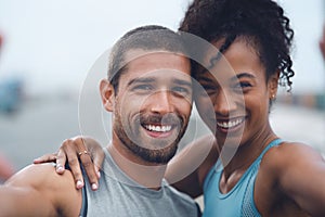 These fitness fanatics love taking selfies. Portrait of a sporty young couple taking selfies together while exercising