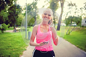 Fitness female athlete enjoying a running workout in park