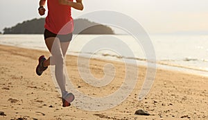 Fitness female runner running at beach