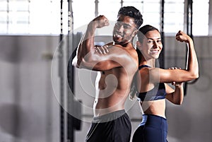 Fitness, flexing muscles and strong couple goals while doing exercise or training in a gym. Portrait of fit sports