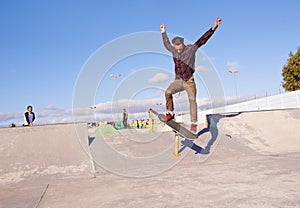 Fitness, freedom and man with skateboard, jump or rail balance at a skate park for stunt training. Energy, adrenaline