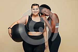 Fitness Friends. Slim And Plus Size Models. Two Different Women In Black Sportswear With Fitness Ball.