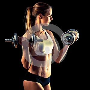 Fitness girl - attractive young woman working out with dumbbells