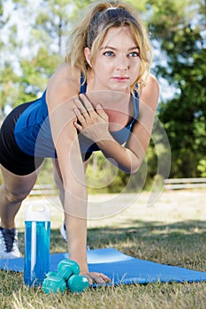 fitness girl doing active plank outdoors