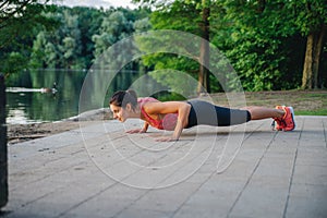 Fitness girl doing push ups outdoor