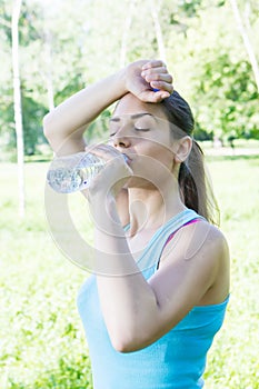 Fitness girl drinking water