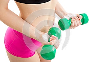 Fitness girl with green dumbbells