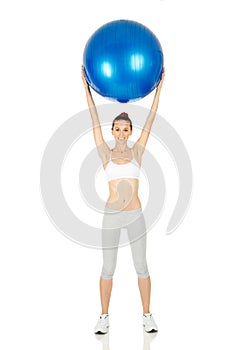 Fitness girl holding exercising ball