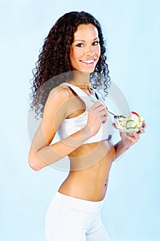 Fitness girl holding fresh salad