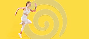 fitness girl jumping in sportswear on yellow background. Woman jumping running banner with mock up copyspace.