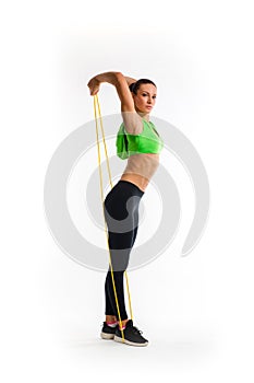 Fitness girl performs exercises with resistance band. Strength and motivation