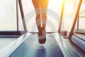 Fitness girl running on treadmill