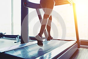 Fitness girl running on treadmill