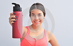 Fitness girl with a shaker and measure tape