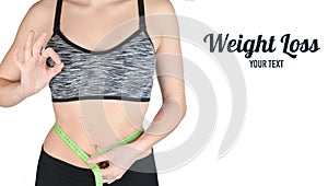 Fitness girl in sports tops measuring ruler waist on white background. The concept of losing weight