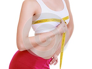 Fitness girl sporty woman measuring her bust size isolated