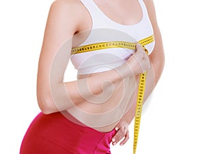Fitness girl sporty woman measuring her bust size isolated photo