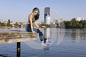 Fitness girl wearing leggings, sneakers and sunglasses