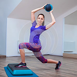 Fitness girl, wearing in sneakers posing on step board with ball