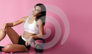 Fitness Girl working out with big weight dumbbell happy smiling on pink. Sport work out concept for woman day 8 march