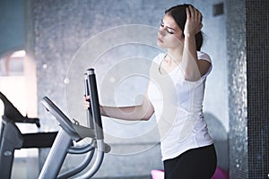 Fitness girl is working out with stepper.Strong brunette with curly hair doing aerobics on stepper