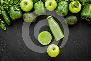 Fitness greeny drink with vegetables on dark background top view mock-up