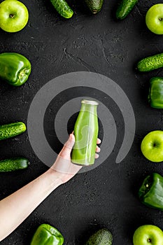 Fitness greeny drink with vegetables on dark background top view mock-up