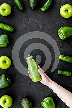 Fitness greeny drink with vegetables on dark background top view mock-up