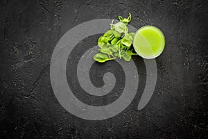 Fitness greeny drink with vegetables on dark background top view mock-up