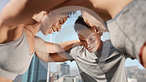 Fitness, group and friends in a huddle before a workout together on a rooftop in an urban city. Sports, training and