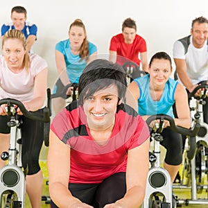 Fitness group of people on gym bike