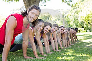 Fitness group planking in park photo