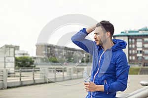 Fitness guy taking a break in between outdoors workouts