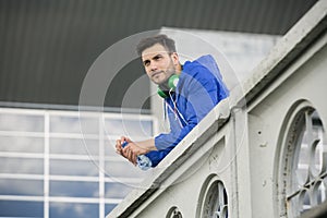 Fitness guy taking a break in between outdoors workouts