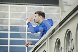 Fitness guy taking a break in between outdoors workouts