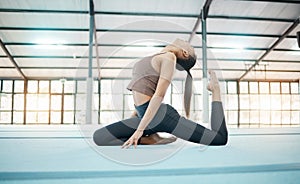 Fitness, gymnastics and balance with a black woman training in a gym for an olympics competition. Exercise, workout and