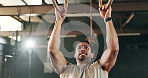 Fitness, gymnastics and man doing a pull up exercise for arm muscle training or workout in gym. Sports, bodybuilding and