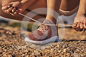 Fitness, hands and tie shoes in nature to start running, workout or training. Sports, wellness and female or woman tying