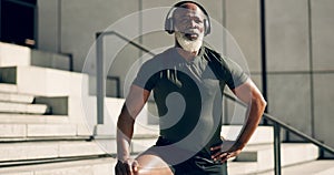 Fitness, headphones and black man on stairs in city, sweat after workout and exercise for body health. Music, senior