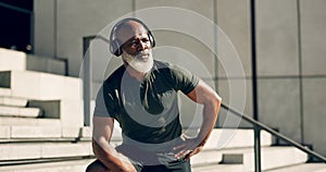 Fitness, headphones and black man on steps in city, sweat after workout and exercise for body health. Music, senior