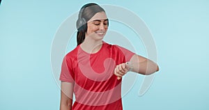 Fitness, headphones and watch of a woman in studio for time, progress or timer. Portrait of happy young person or