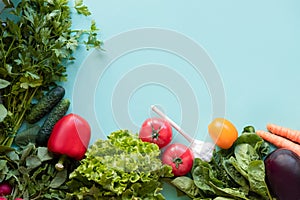 Fitness and healthy food concept. Fresh vegetables on blue background. Place for text.